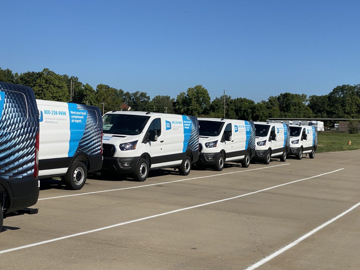 A row of service vans branded to the same standard